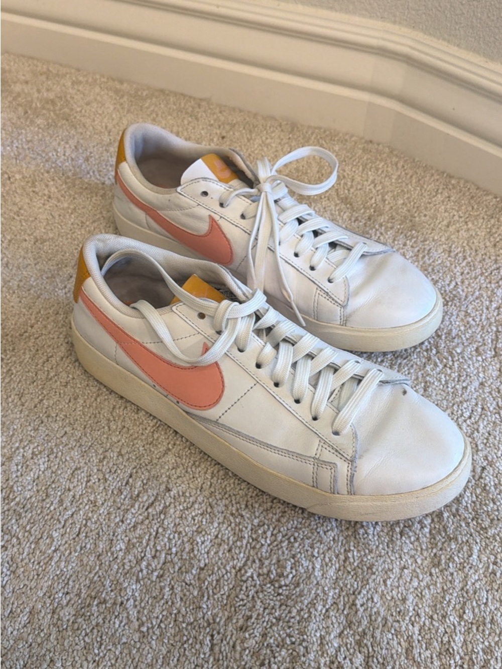 Nike White Low-Top Sneakers with Coral Swoosh and Yellow Heel Tab